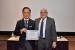 Dr. Nagib Callaos, General Chair, giving Prof. Shigehiro Hashimoto the best paper award certificate of the session "Biomedical Engineering." The title of the awarded paper is "Effect of Couette Type of Shear Stress Field with Axial Shear Slope on Deformation and Migration of Cell: Comparison Between C2C12 and HUVEC."